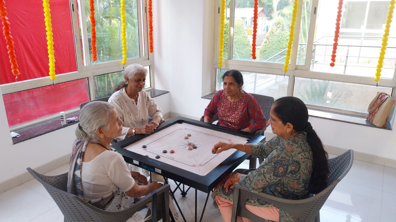 A circle of senior women chatting at the clubhouse